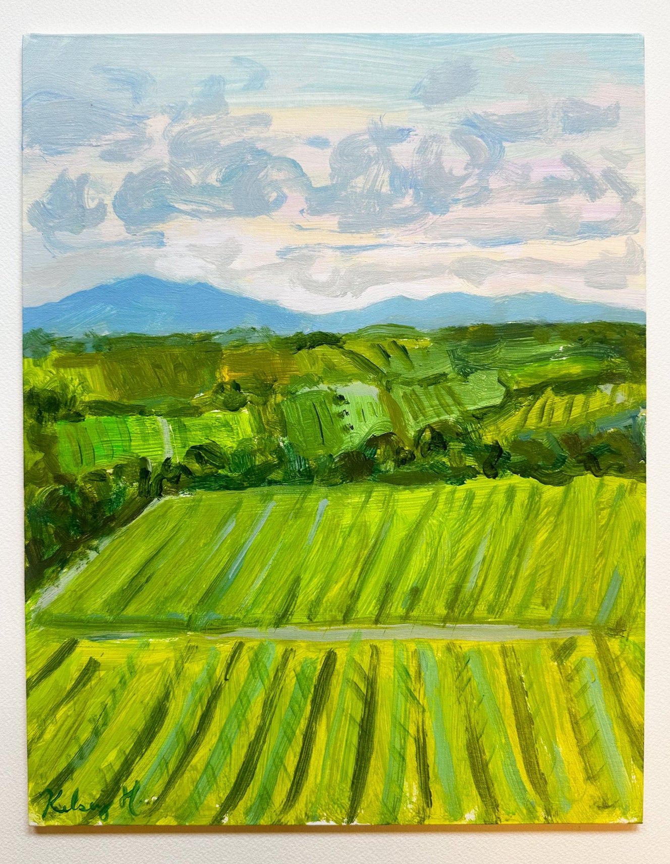 Painting of a landscape with green fields and mountains under a blue sky.