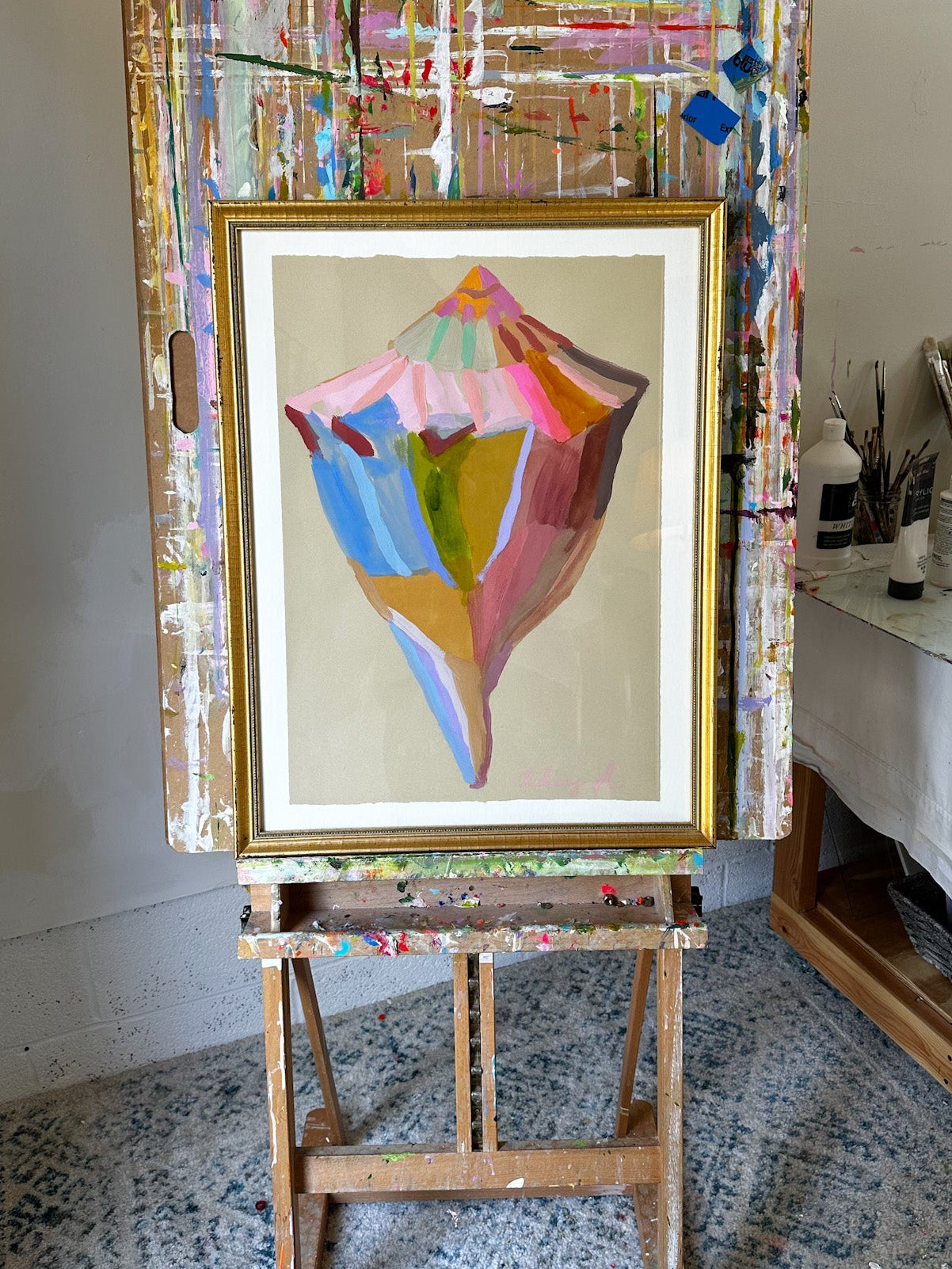 Abstract painting on an easel in a studio setting