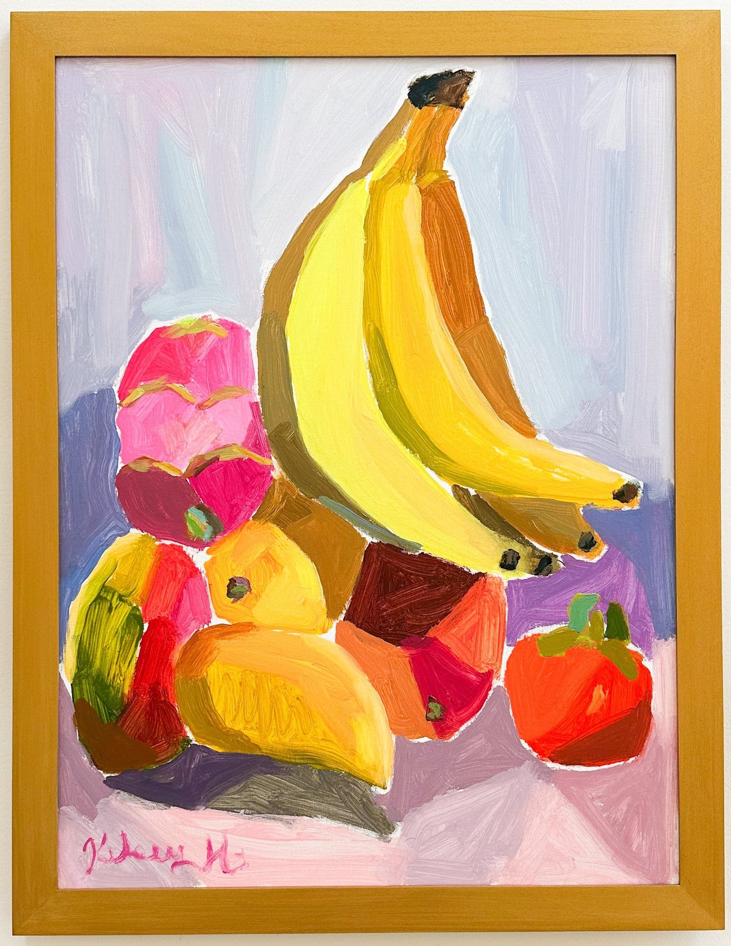 Framed painting of colorful fruit including bananas, mangos, pitaya, and a persimmon on a light purple background.