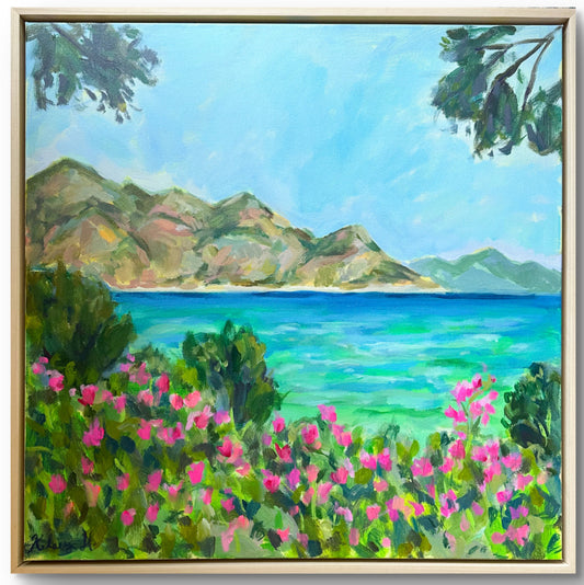 Framed painting of a coastal landscape with mountains, sea, and pink flowers.