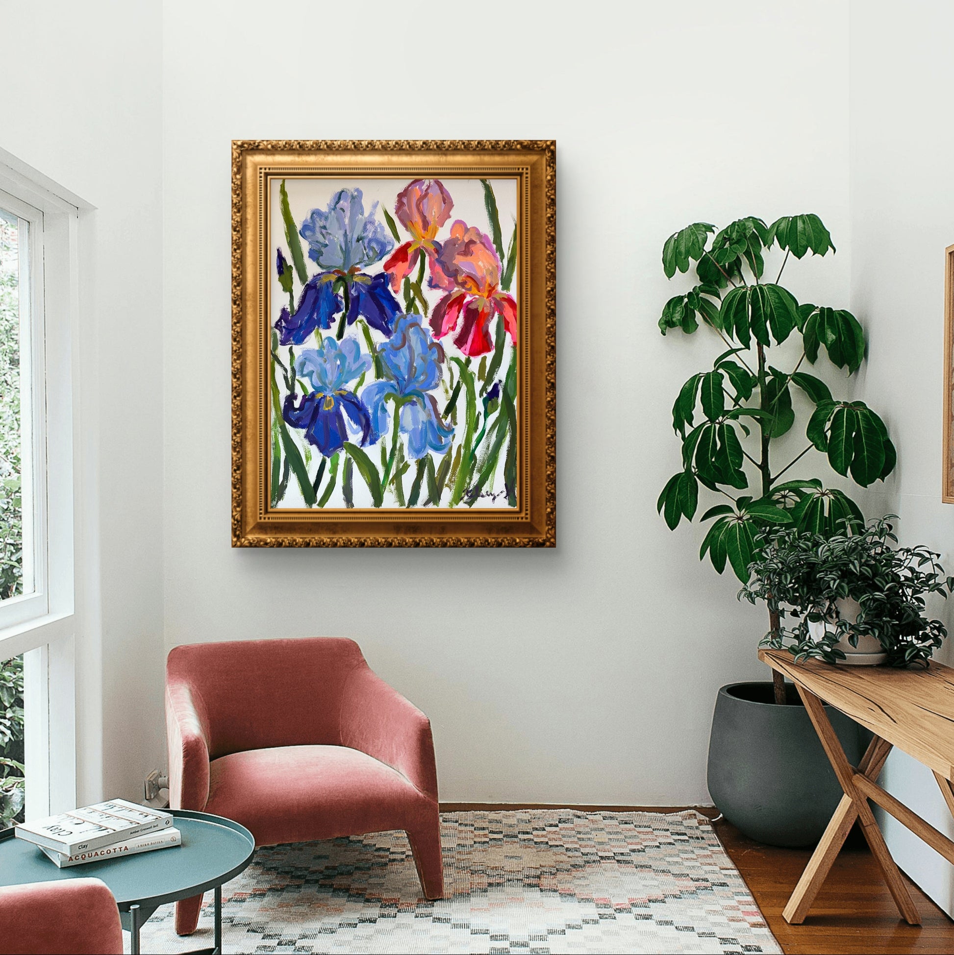 Living room with a colorful floral painting, red armchair, and plants.