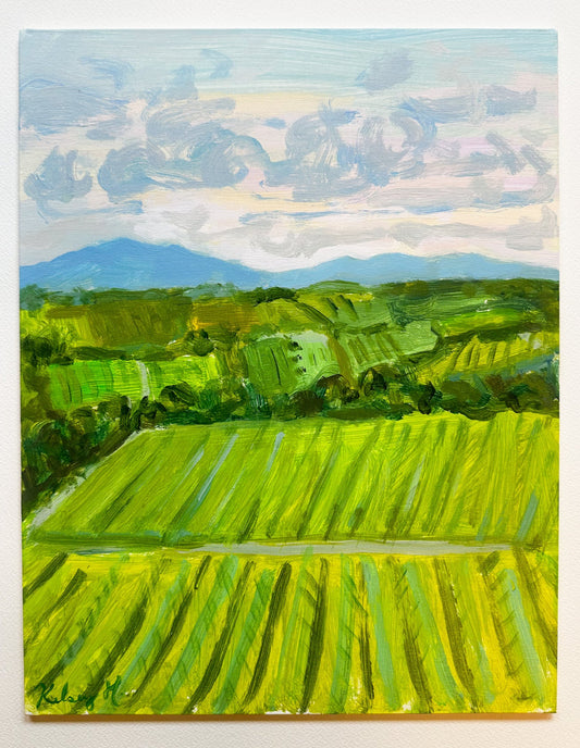 Painting of a landscape with green fields and mountains under a blue sky.