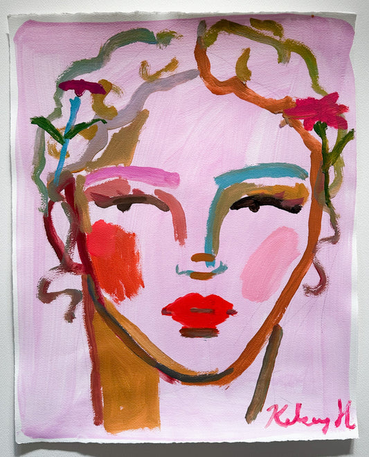 Abstract art piece with colorful face design on a pink background