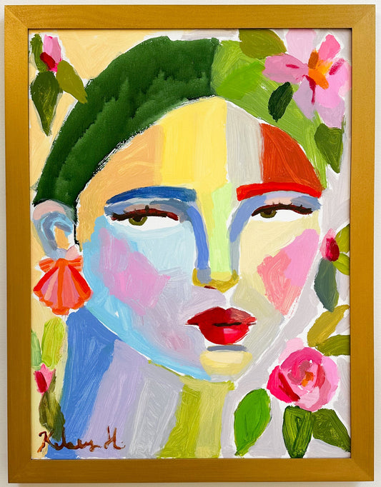 Colorful abstract painting of a face with flowers in a wooden frame.