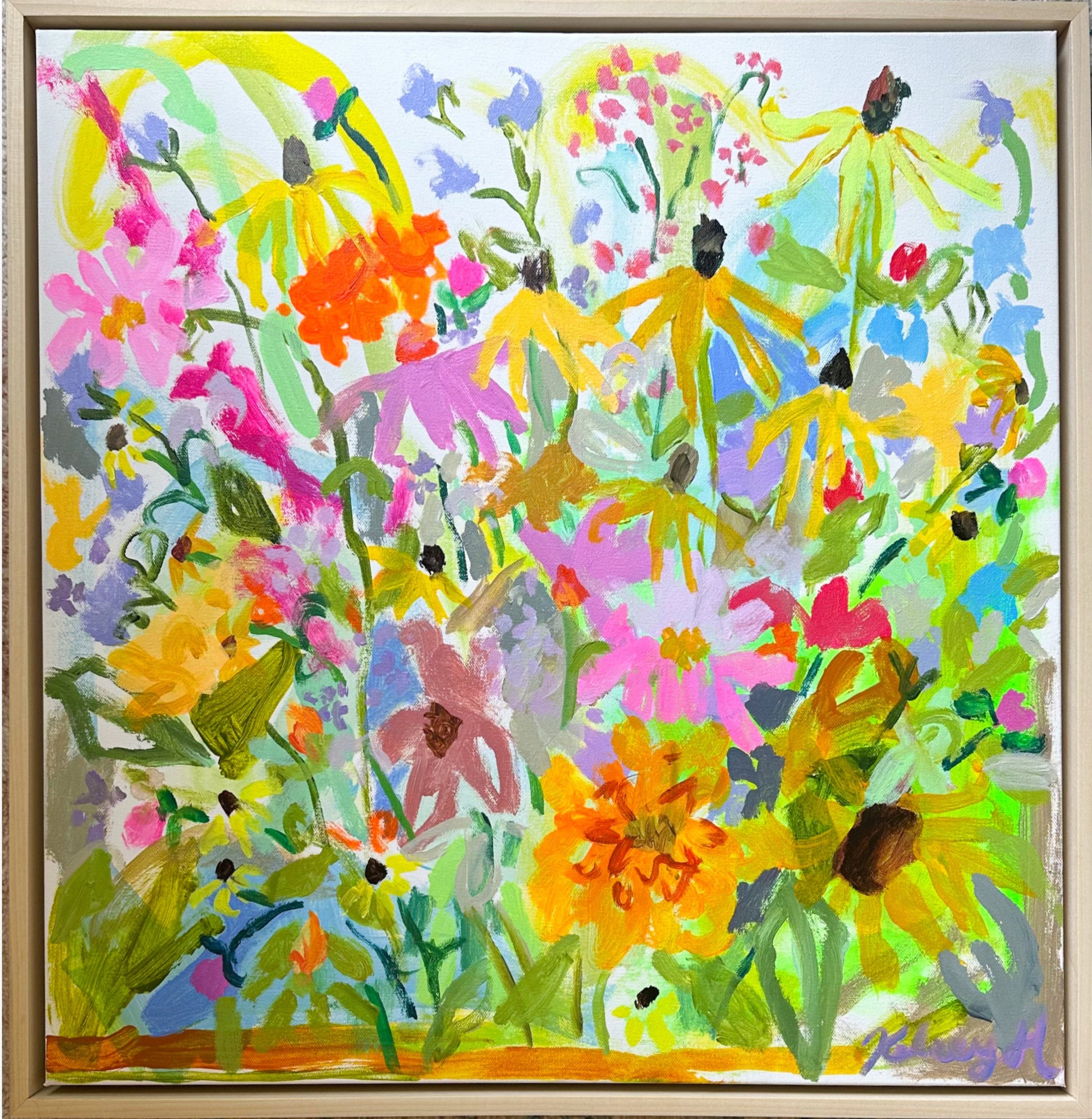 Colorful floral painting in a wooden frame on a white wall